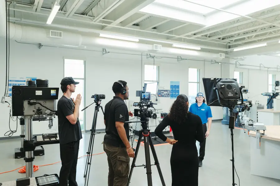Crew setting up cameras and monitors to film a technician interview