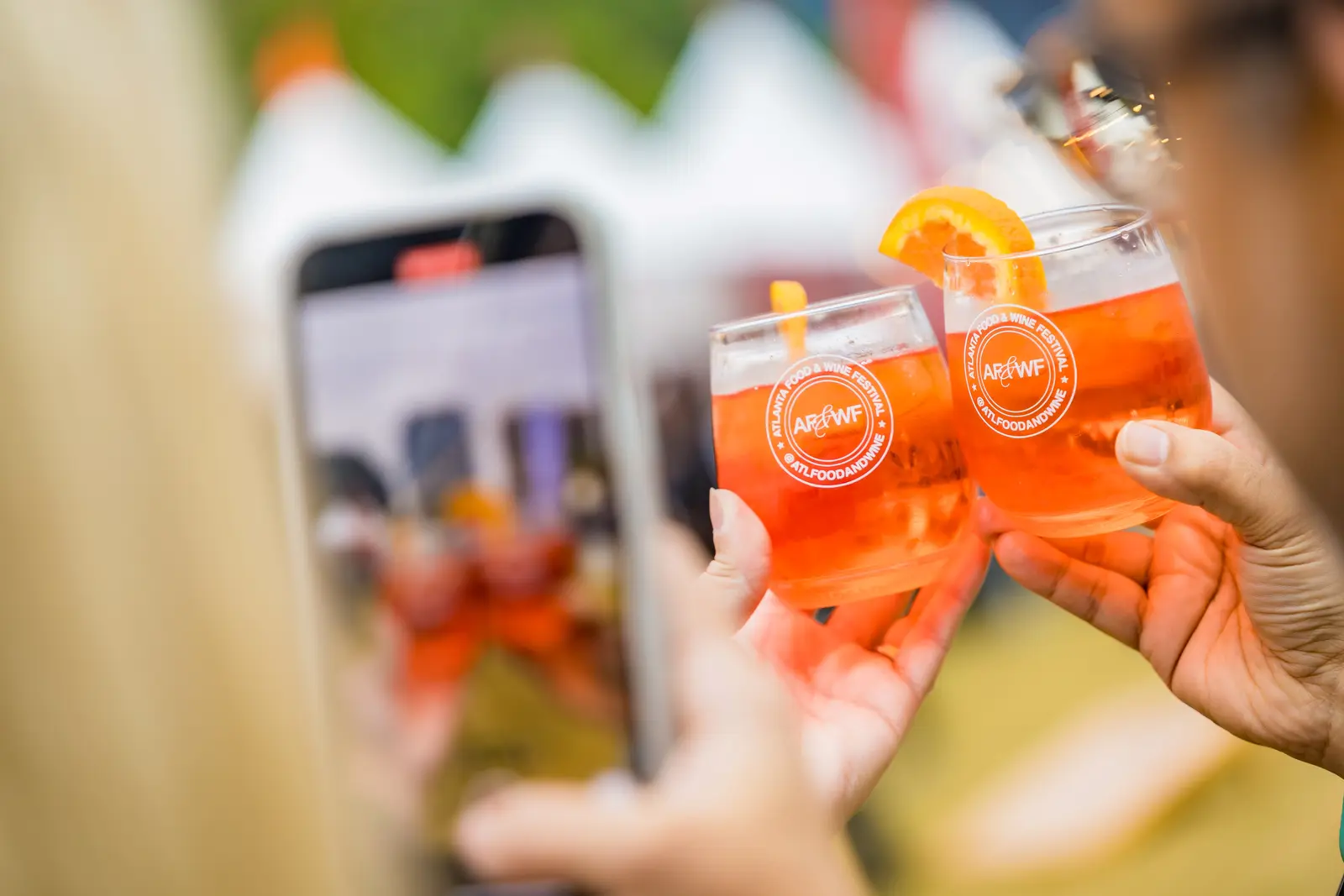 Event photography in Atlanta by Hylton Media Group: guests toasting at Atlanta Food & Wine Festival