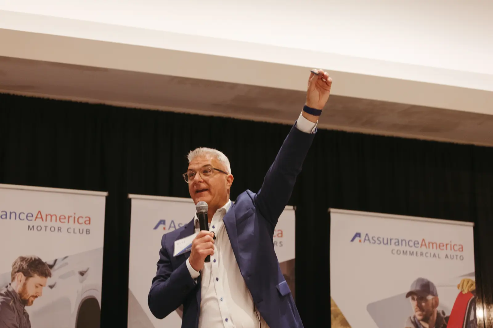 Corporate event photography by Hylton Media Group: speaker on stage at a conference