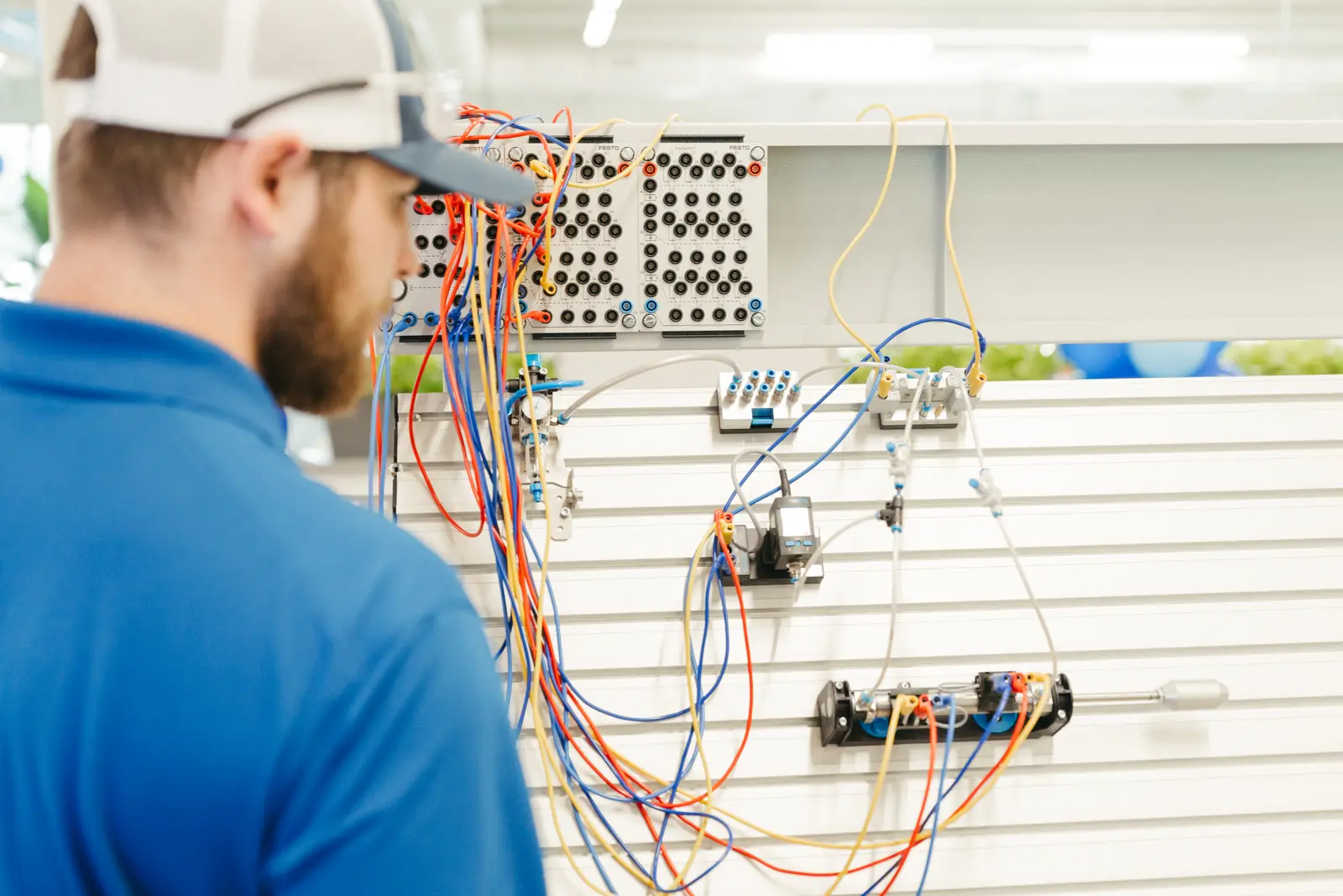 Corporate photography by Hylton Media Group: technician wiring a training panel