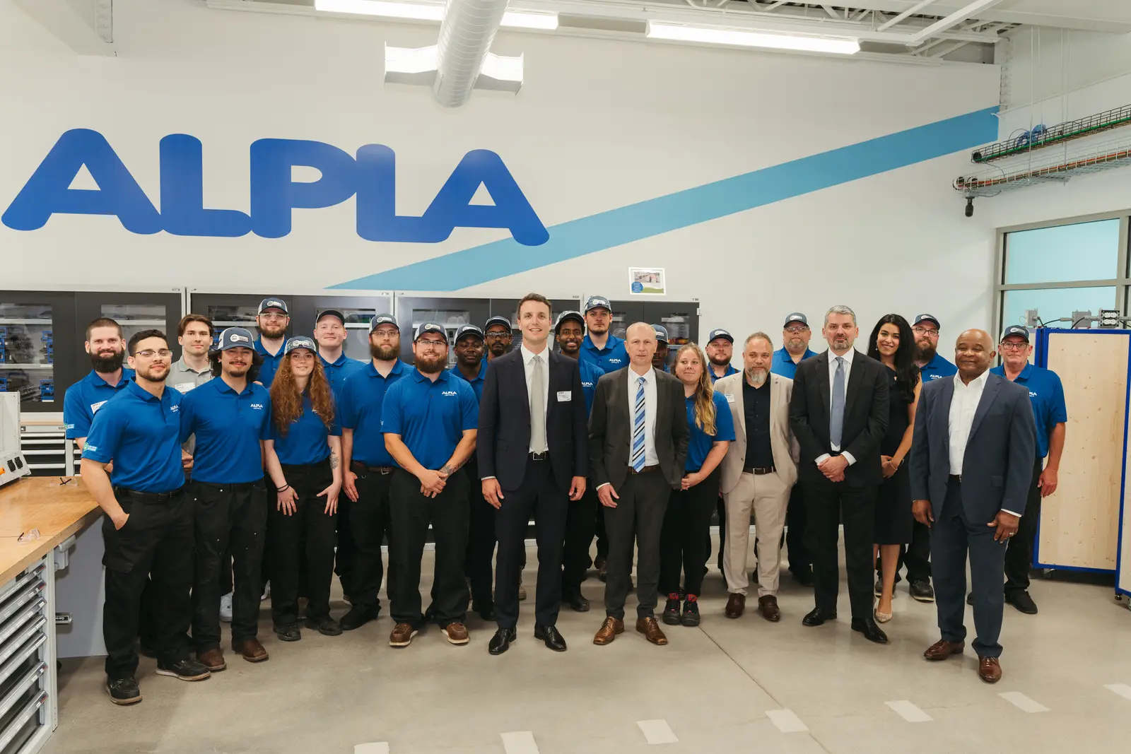 Team photography by Hylton Media Group: full team group photo inside the ALPLA facility